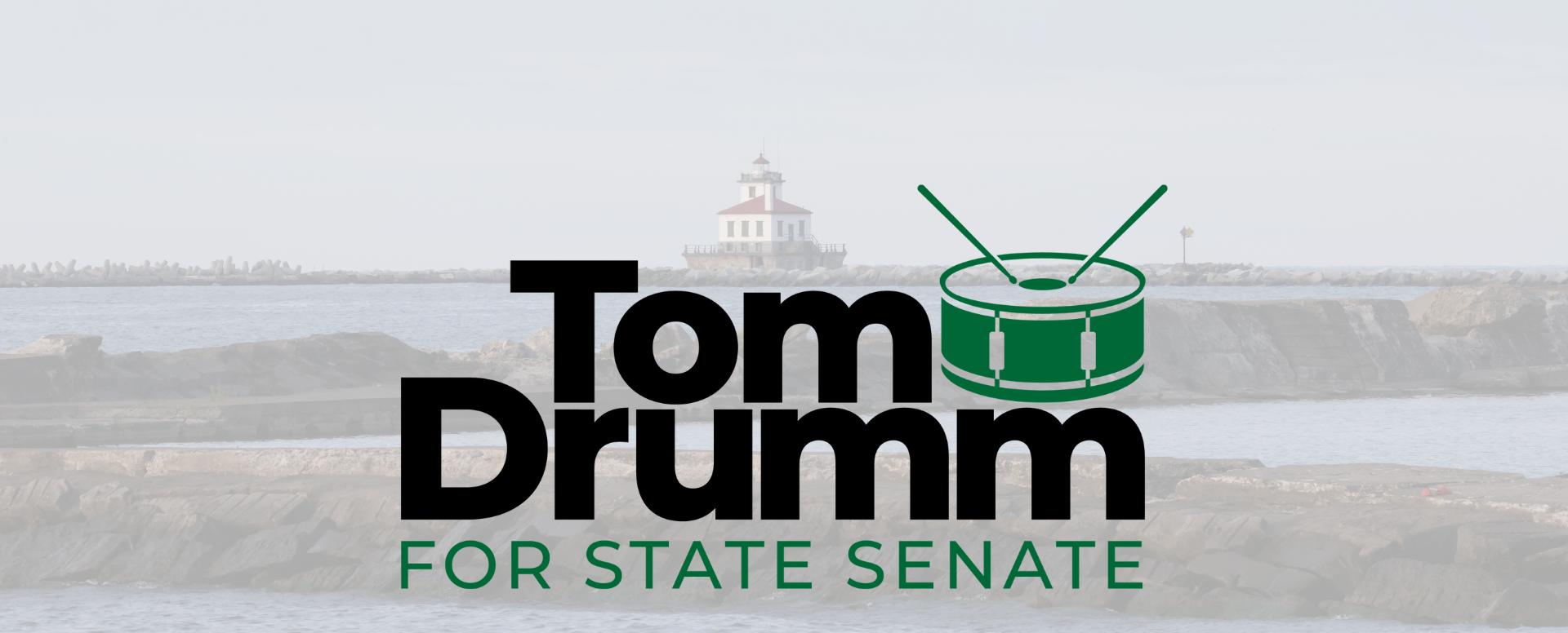 Image of a lighthouse and Tom Drumm For State Senate logo.